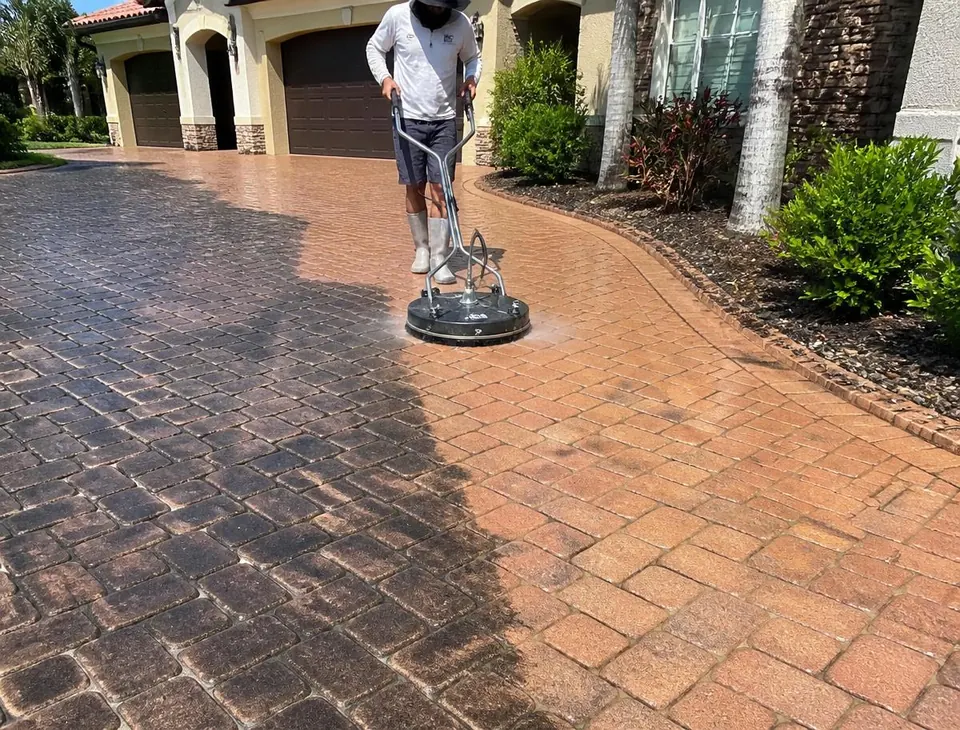 Pressure washing a stained concrete driveway at a Deltona, Florida home